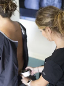 doctor checking a patient's back